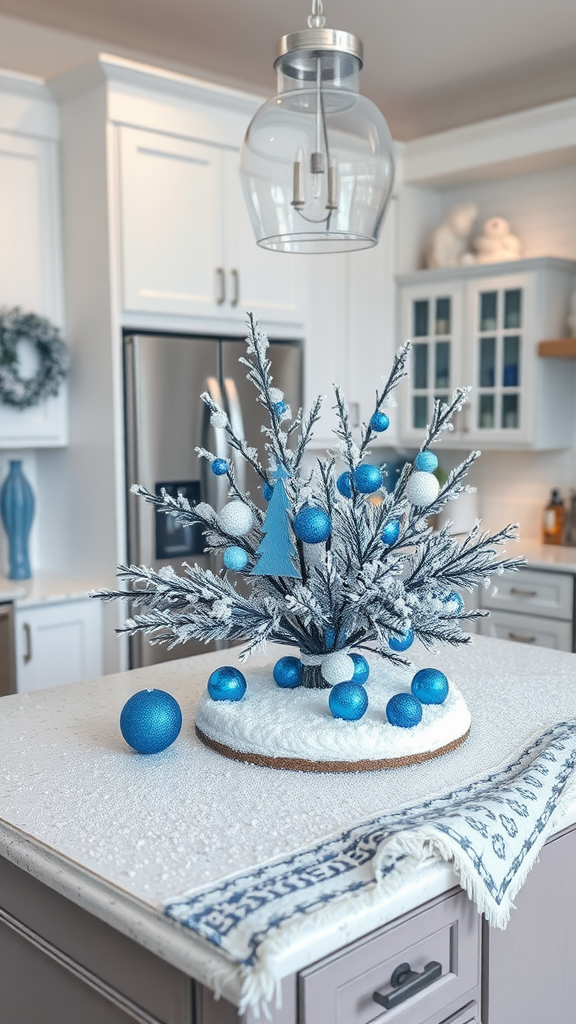 A winter-themed kitchen island decor featuring a small snowy tree with blue ornaments and a white snowy base.